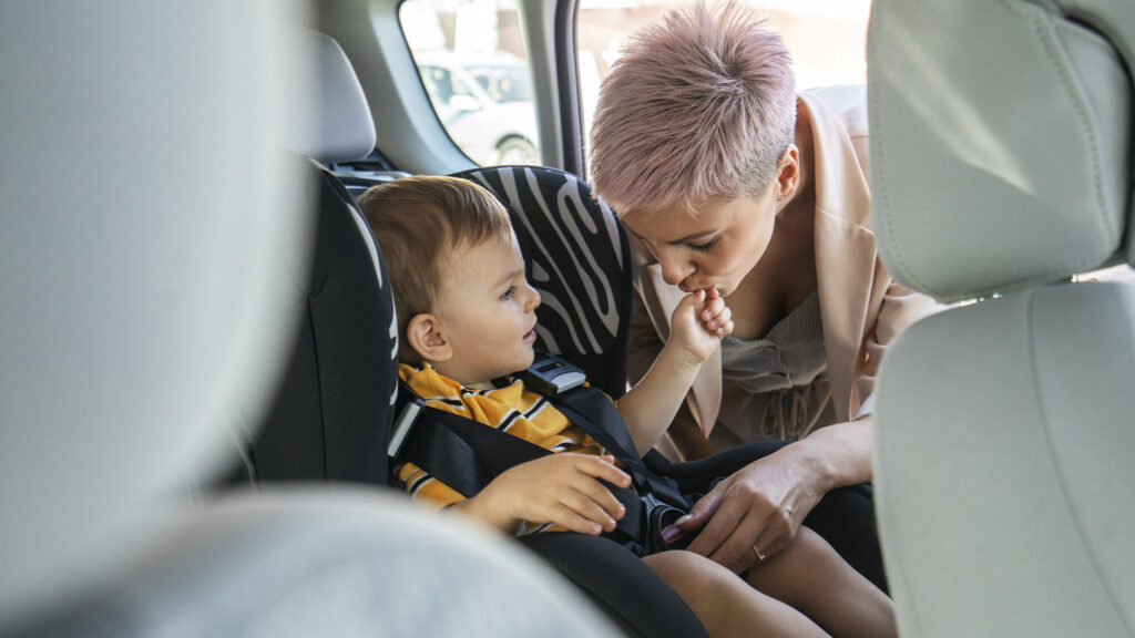 mother puts kid in childseat